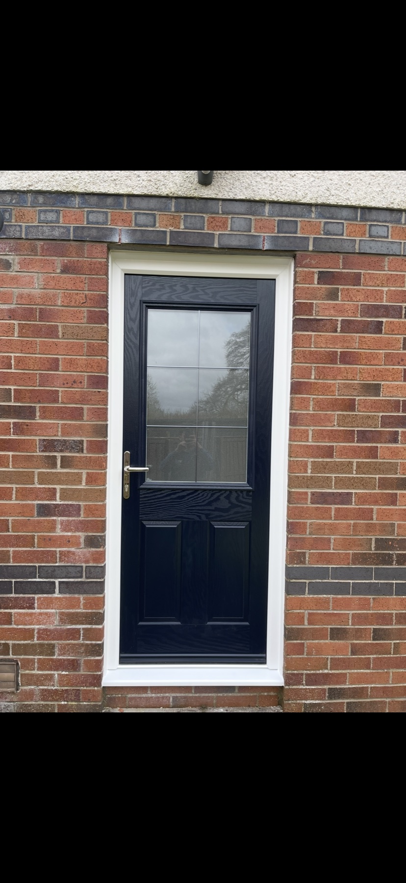 Navy glazed composite door fitted in brick property